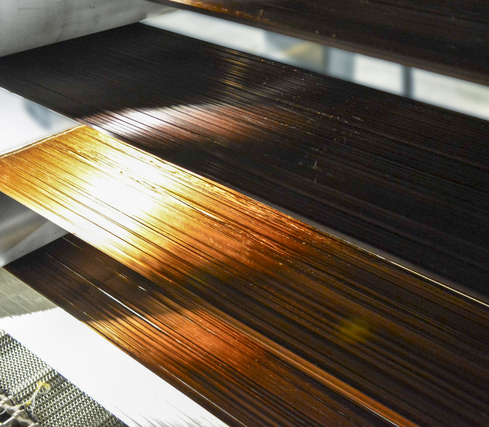 The photo shows carbon fibre being processed at a much higher throughput than is possible with conventional methods